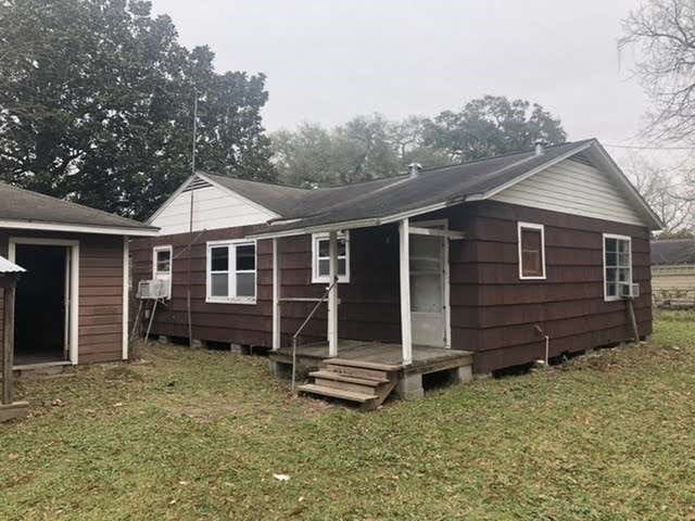 rear view of property with a yard