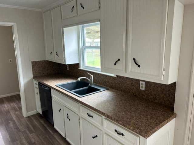 kitchen with black dishwasher, backsplash, dark hardwood / wood-style floors, and white cabinetry