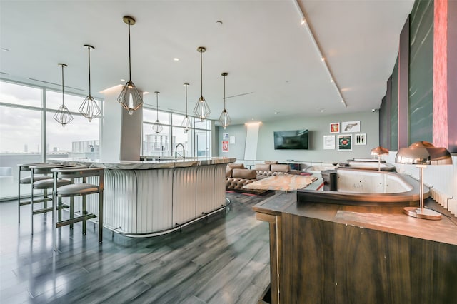 kitchen with pendant lighting, dark hardwood / wood-style flooring, and expansive windows