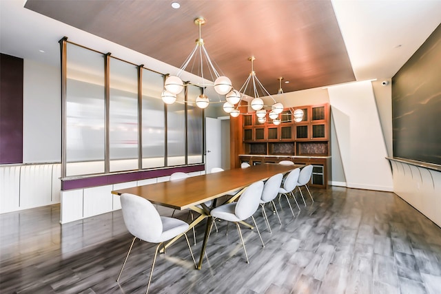 unfurnished dining area with hardwood / wood-style floors and a notable chandelier