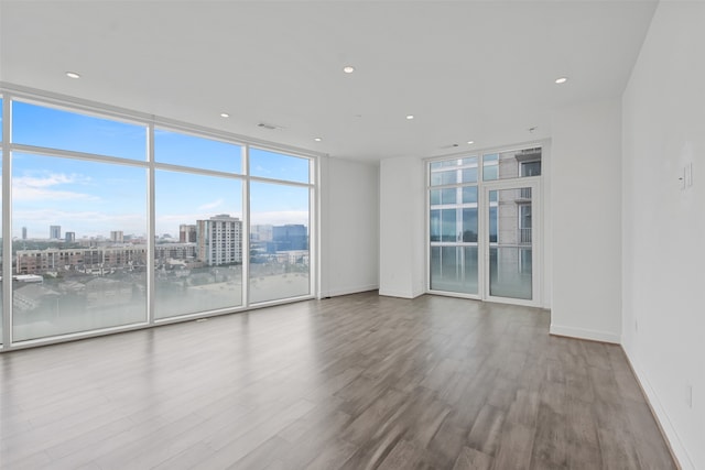 spare room with hardwood / wood-style flooring