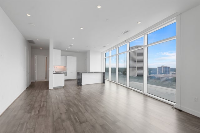 unfurnished living room featuring dark wood-type flooring