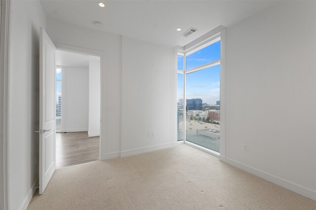 spare room with light colored carpet