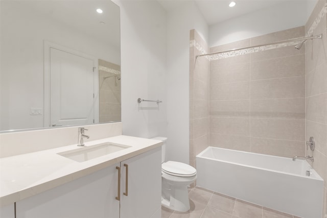 full bathroom featuring tile patterned flooring, tiled shower / bath, toilet, and vanity