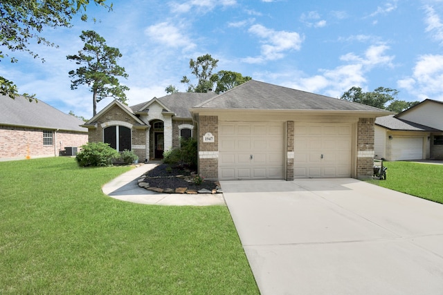 ranch-style house featuring a front yard, central air condition unit, and a garage