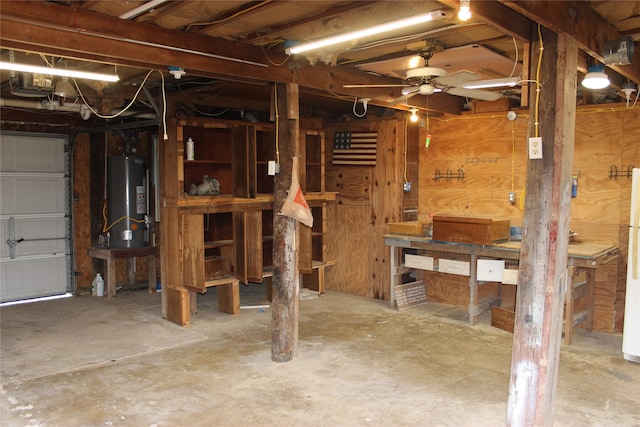 basement featuring a workshop area, gas water heater, and ceiling fan