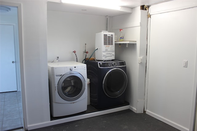 laundry room with tile patterned flooring and washer and dryer