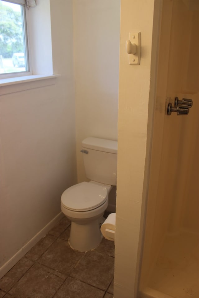 bathroom with toilet and tile patterned flooring