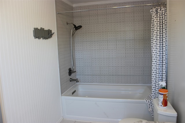 bathroom featuring shower / bath combo with shower curtain and toilet