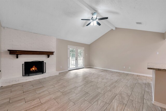 unfurnished living room featuring a textured ceiling, french doors, a brick fireplace, lofted ceiling with beams, and ceiling fan