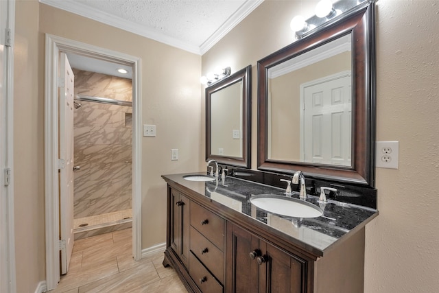 bathroom featuring ornamental molding, vanity, a textured ceiling, and tiled shower