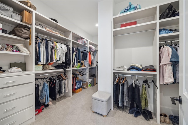 spacious closet featuring light carpet