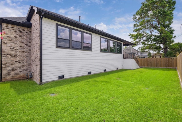 back of house featuring a yard