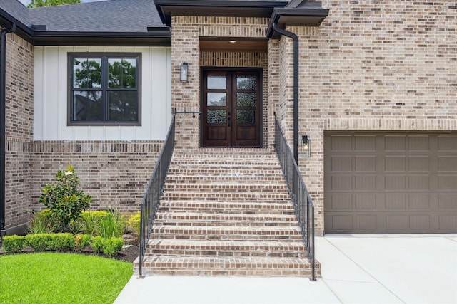 property entrance featuring a garage and french doors