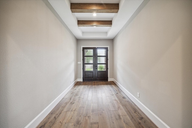 doorway to outside with beamed ceiling, light hardwood / wood-style floors, and french doors