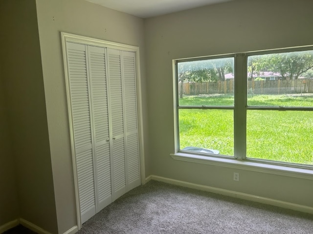 unfurnished bedroom with carpet and a closet