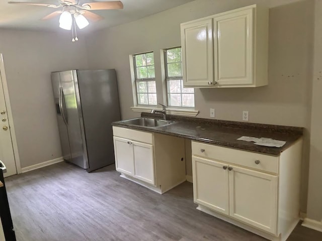 kitchen with ceiling fan, white cabinets, stainless steel fridge with ice dispenser, light wood-type flooring, and sink