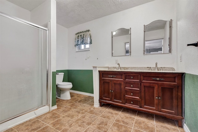 bathroom with an enclosed shower, toilet, a textured ceiling, and vanity