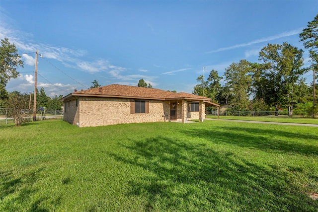 rear view of property with a yard