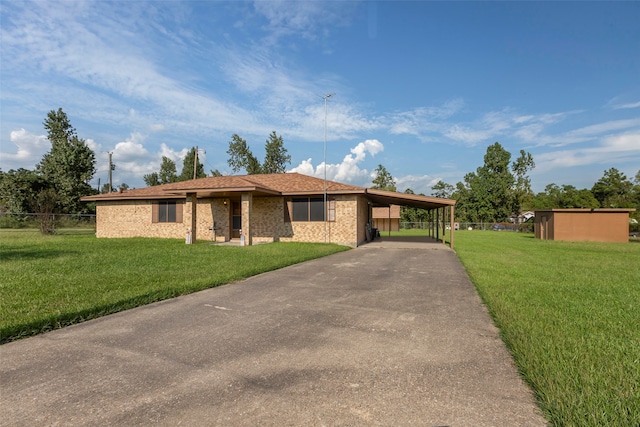 ranch-style home featuring a carport and a front yard