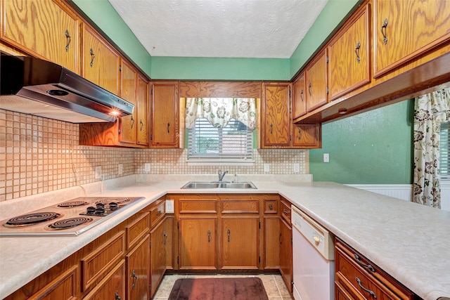 kitchen featuring white appliances, light tile patterned floors, decorative backsplash, and sink