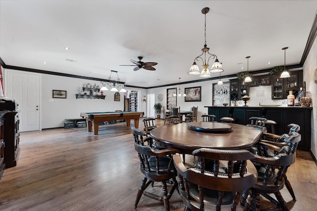 dining space featuring wood-type flooring, billiards, bar area, ceiling fan, and crown molding