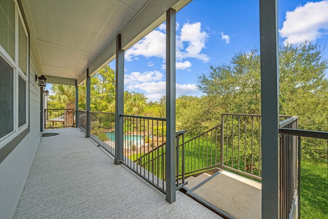 balcony featuring a fenced in pool