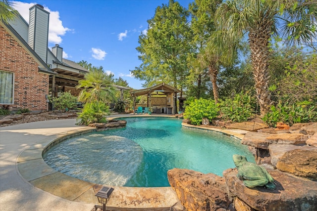 view of swimming pool with a gazebo and a patio area