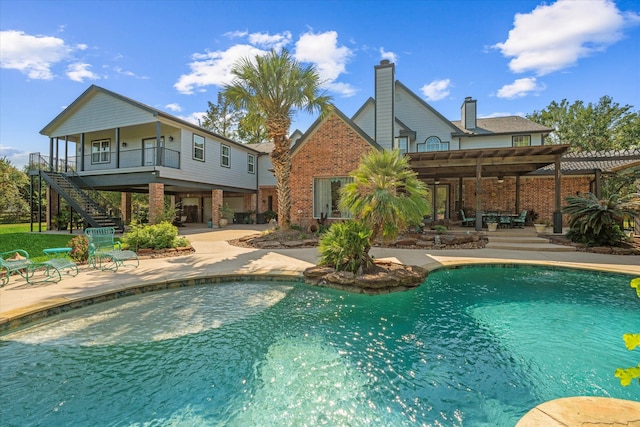 view of pool with a patio and a pergola