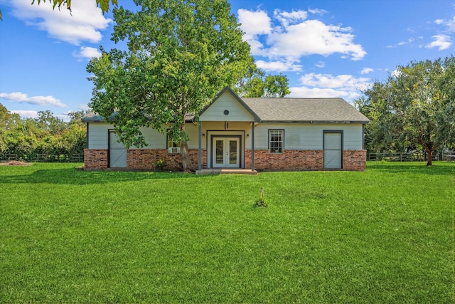 view of front of home with french doors and a front yard