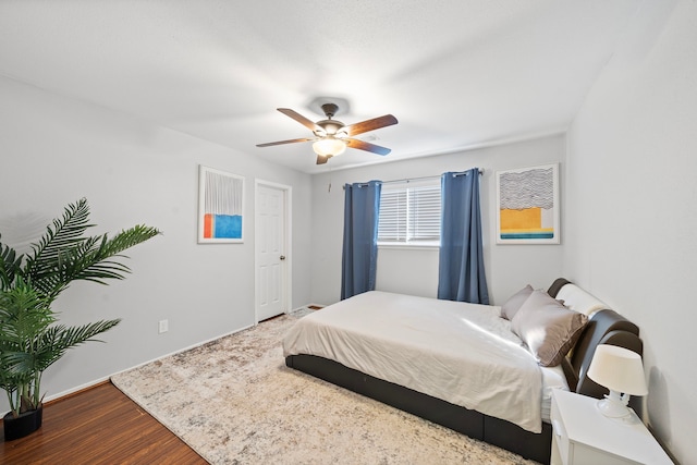 bedroom with wood finished floors and a ceiling fan