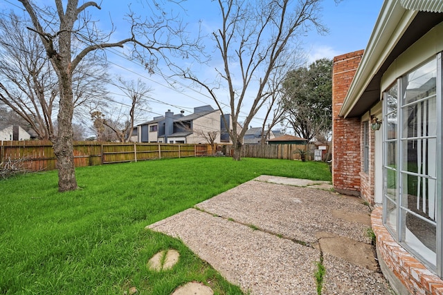 view of yard with a patio area and a fenced backyard