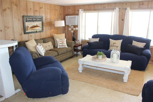 living room featuring a wall mounted air conditioner, light tile patterned flooring, and wooden walls