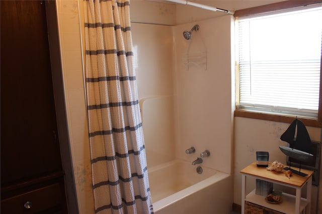 bathroom with shower / tub combo with curtain