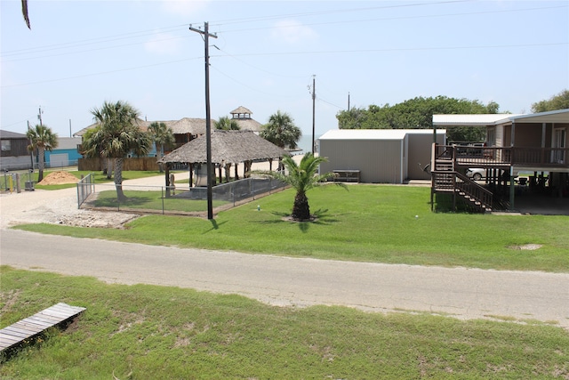 exterior space with a deck, a yard, and a gazebo