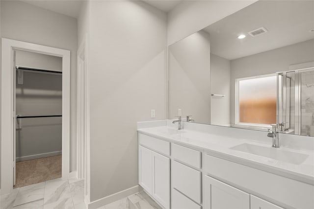 bathroom with walk in shower and vanity