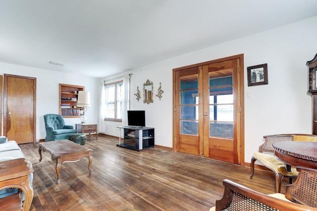 living room featuring french doors, dark hardwood / wood-style flooring, and a wealth of natural light