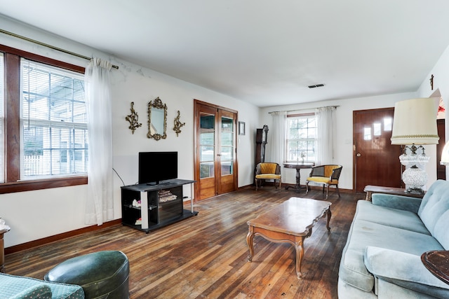 living room with french doors and dark hardwood / wood-style flooring