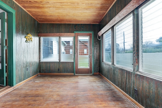 unfurnished sunroom with wood ceiling