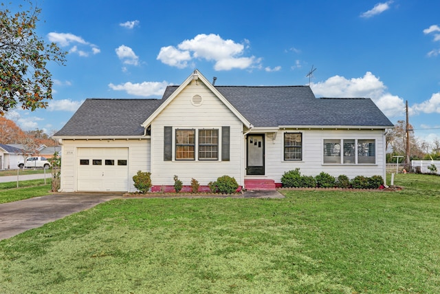 ranch-style home featuring a garage and a front lawn