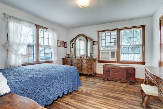 bedroom featuring hardwood / wood-style flooring and cooling unit