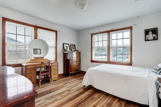 bedroom featuring multiple windows and hardwood / wood-style flooring