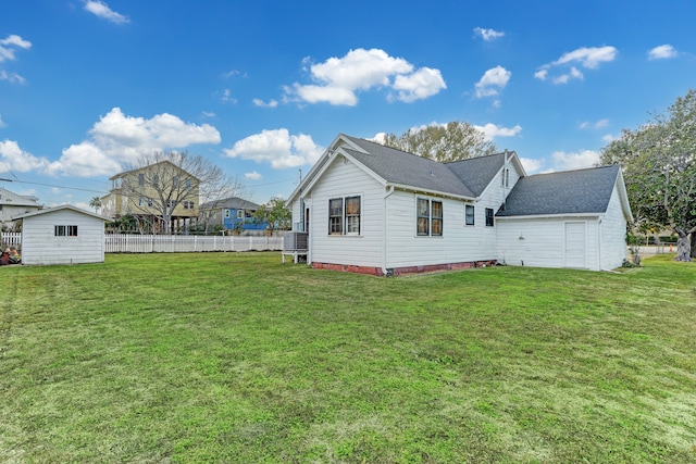 view of side of home with a lawn and a storage unit