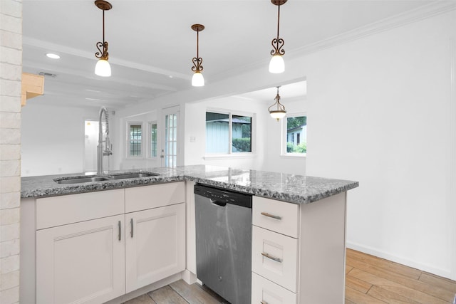 kitchen featuring a sink, pendant lighting, white cabinets, and stainless steel dishwasher