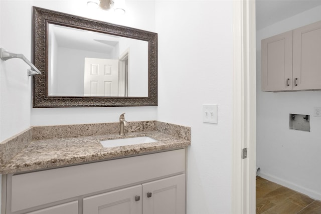 bathroom with vanity and baseboards