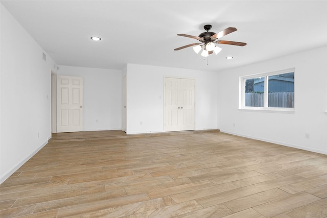 spare room with recessed lighting, visible vents, light wood-style floors, ceiling fan, and baseboards