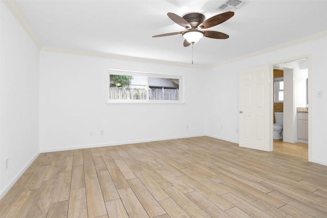 unfurnished room featuring ornamental molding, light wood finished floors, visible vents, and baseboards