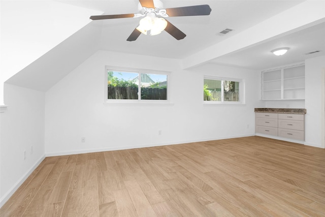 bonus room featuring a healthy amount of sunlight, visible vents, light wood-style flooring, and baseboards