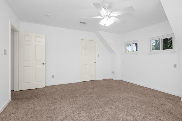 additional living space with carpet, visible vents, ceiling fan, and baseboards