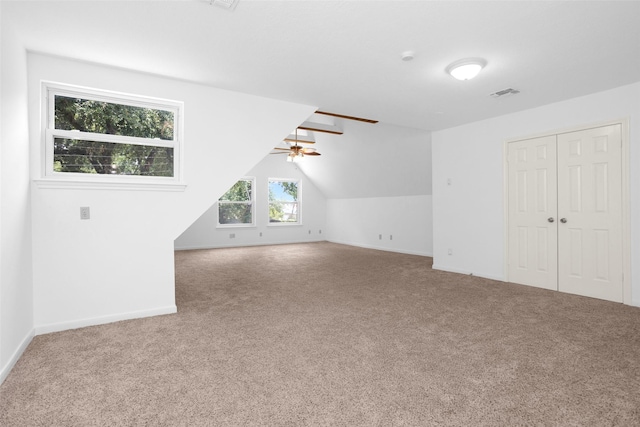 bonus room featuring vaulted ceiling, ceiling fan, carpet flooring, and visible vents